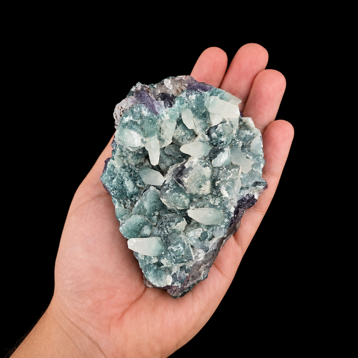 Amethyst with Manganocalcite cluster front view in hand, showing purple amethyst, pale blue-green areas and natural crystal points