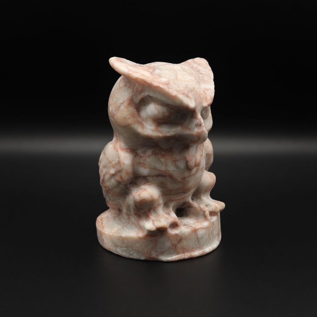 Profile view of a premium 350g hand-carved Red Line Jasper owl ornament. Detailed artisanal stone carving featuring distinct crimson banding