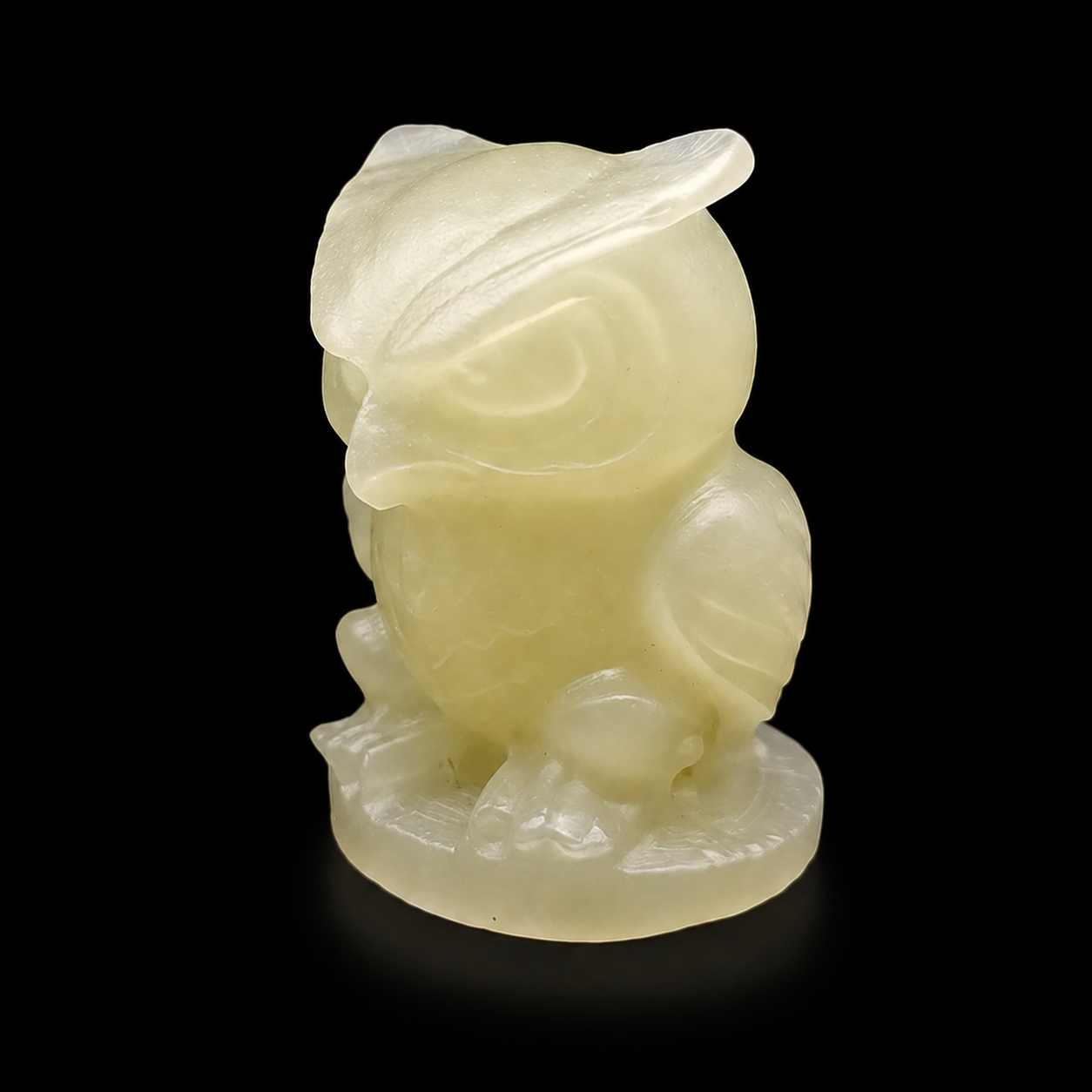 Side angle green onyx owl figurine showing smooth carving and natural translucency