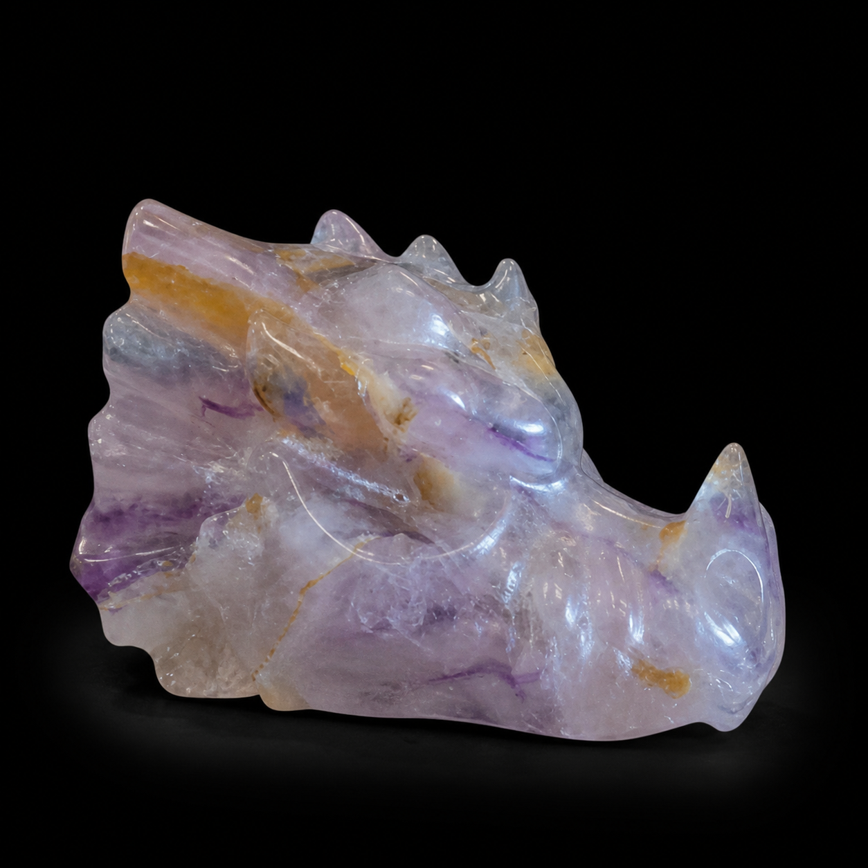 Fluorite dragon head opposite side view showing polished carving, purple veins and golden natural inclusions