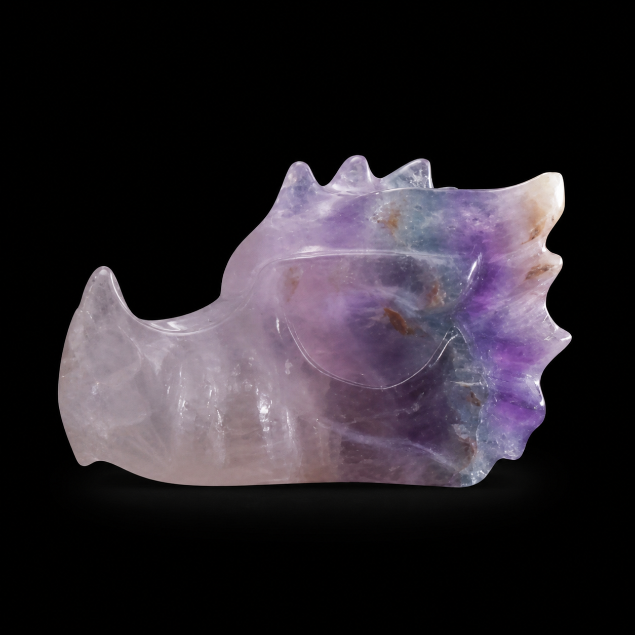 Fluorite dragon head side view held under light showing translucent purple and pale mineral zoning