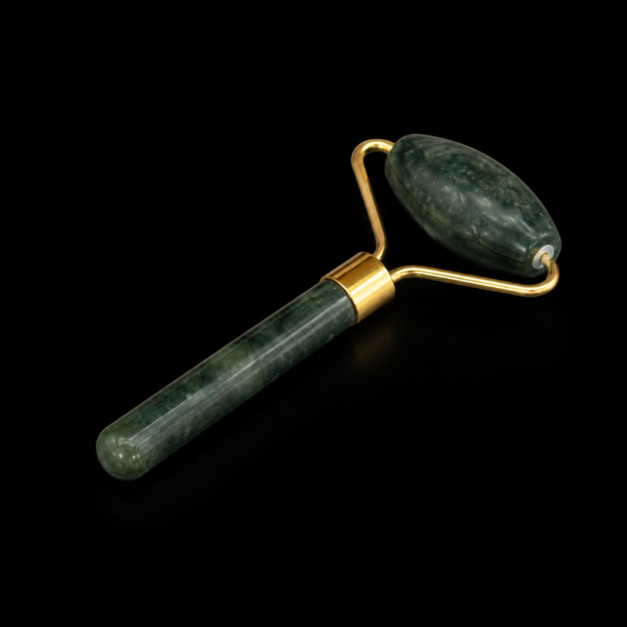 Jade facial massage roller with elongated oval roller head and gold-tone fittings on a black background.