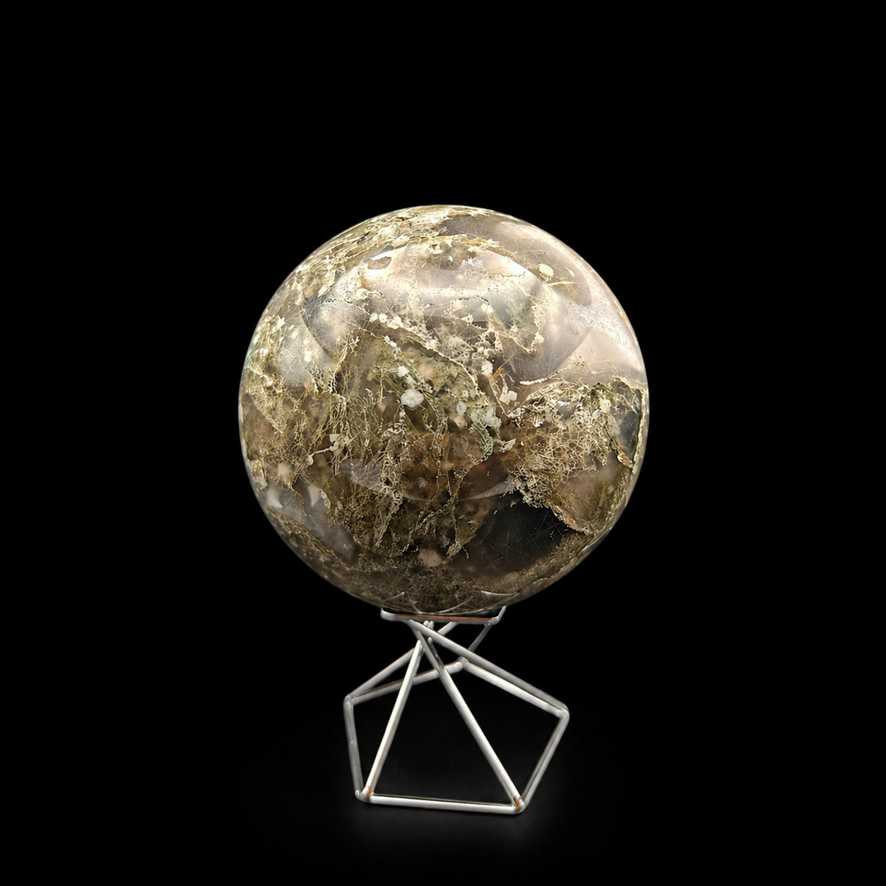 Front view of a polished moss agate sphere 840g with natural scenic inclusions on a metal stand