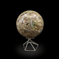 Slightly rotated front view of a polished moss agate sphere 840g showing green, beige and translucent inclusions