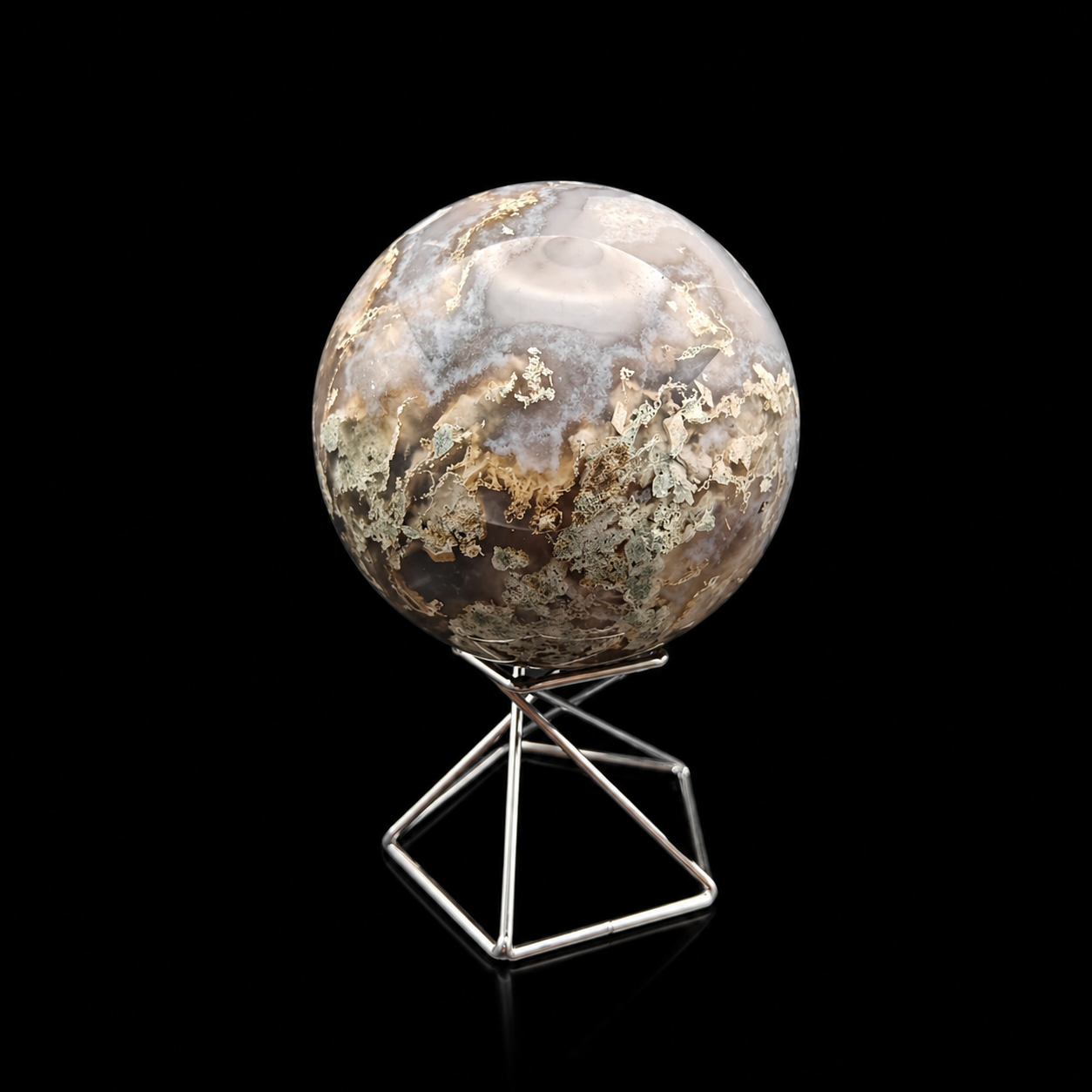 Slightly rotated front view of a polished moss agate sphere 460g showing pale green, beige and translucent natural inclusions