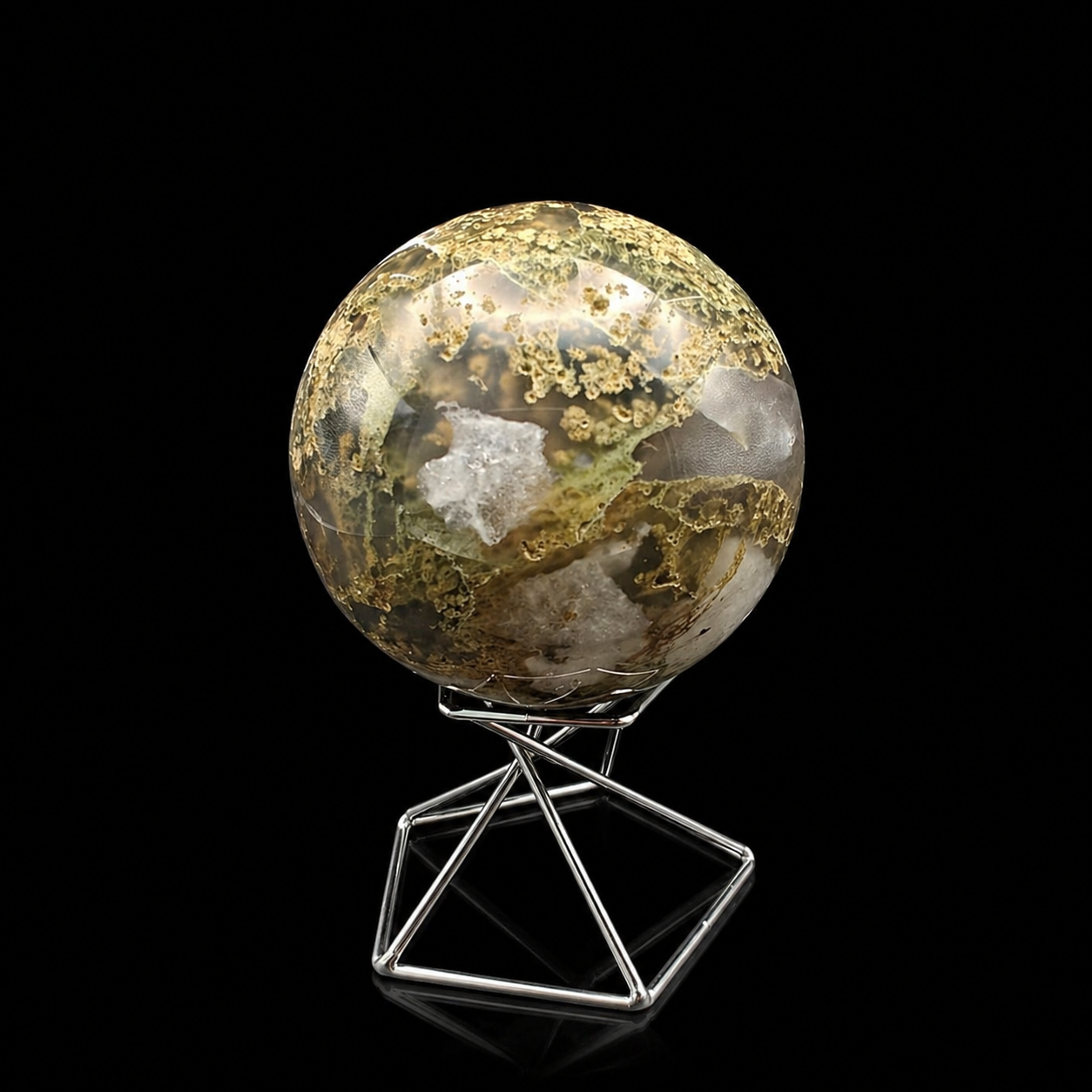 Slightly rotated front view of a polished moss agate sphere 365g showing golden moss-like inclusions, translucent grey sections and earthy brown natural patterns on a metal stand