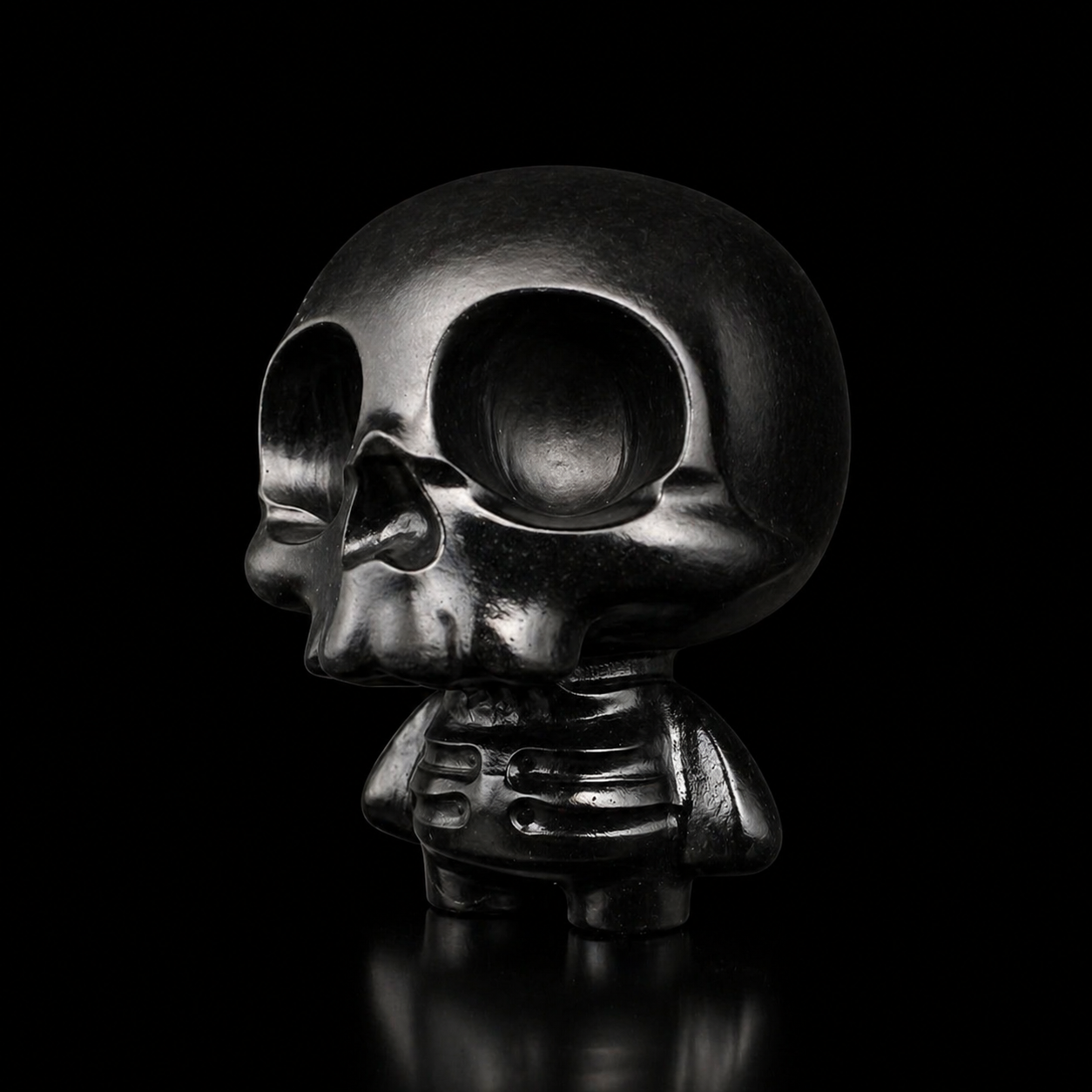 Black obsidian skull figure with glossy polished finish and detailed carved body, angled side view