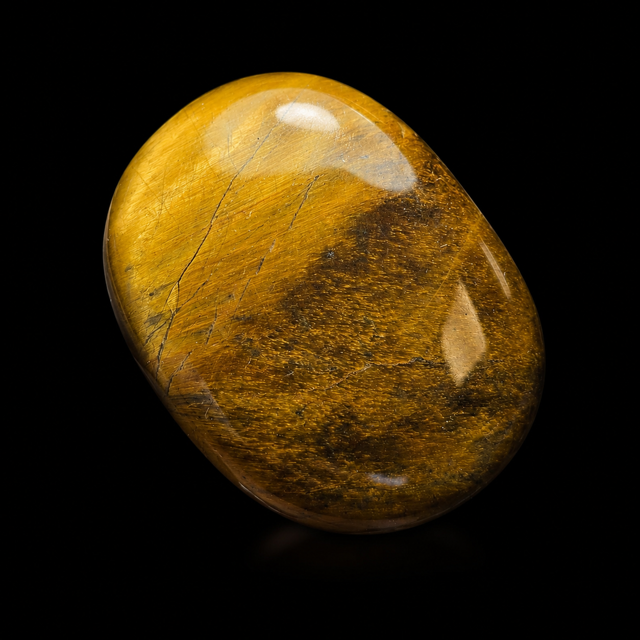 Polished Tiger’s Eye palm stone, close-up detail view showing golden brown chatoyancy, natural bands and glossy finish