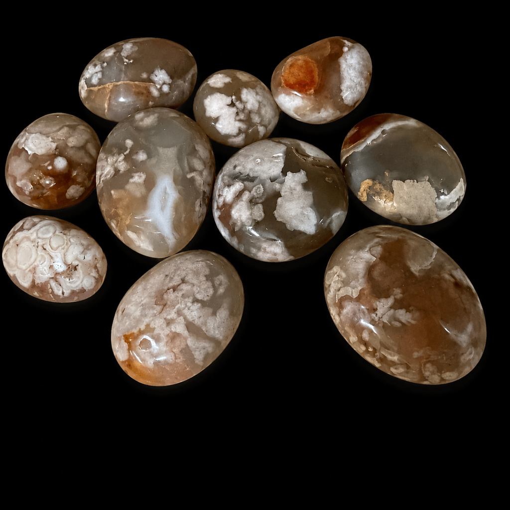 Flower Agate palm stone selection in different sizes, showing polished natural agate pieces with beige, brown and cream floral patterns.