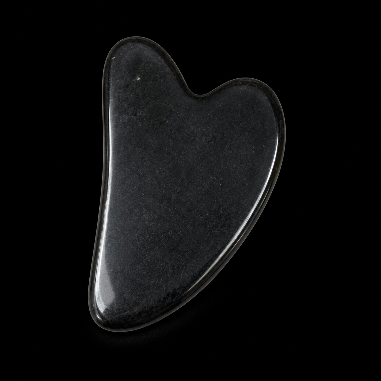 Polished black obsidian Gua Sha tool, front angled view showing glossy finish and smooth curved massage shape.
