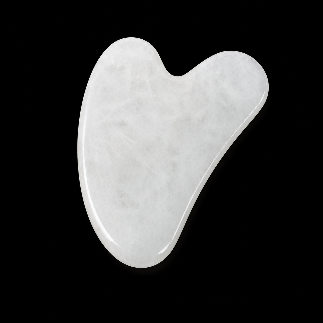 Polished white quartz Gua Sha tool, front angled view showing smooth curved massage shape and soft natural cloudy pattern.