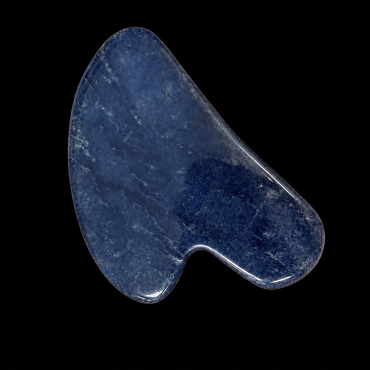 Polished sodalite Gua Sha tool, front angled view showing deep blue colour, smooth curved massage shape and subtle natural variations.