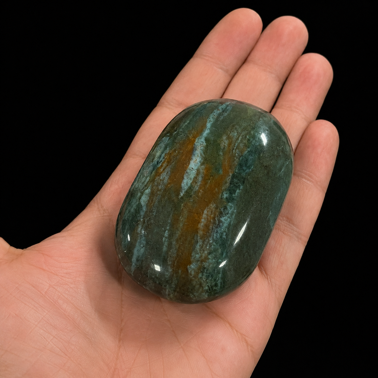 Ocean Jasper XL palm stone held in hand, polished deep green mineral soap stone with earthy brown natural pattern | HeyMiner