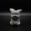 Front view of a unique Yooperlite Pikachu-inspired figure with speckled grey, black, reddish and pale natural mineral patterns