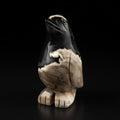 Front three-quarter view of natural moss agate penguin carving displaying the face, beak and body with dramatic black and beige patterns, unique 526g piece