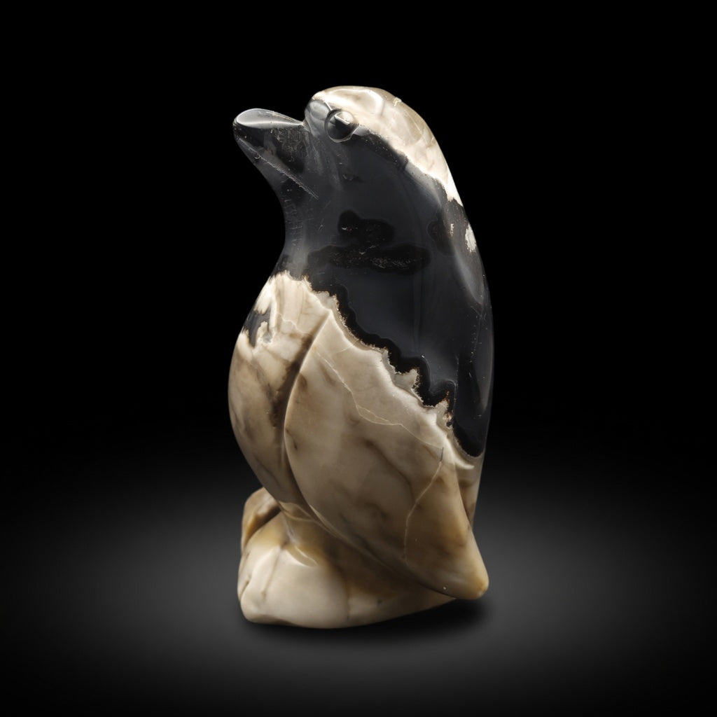 Side profile view of hand-carved moss agate UV-reactive penguin sculpture highlighting the natural veining, polished surface and full profile, unique 526g piece