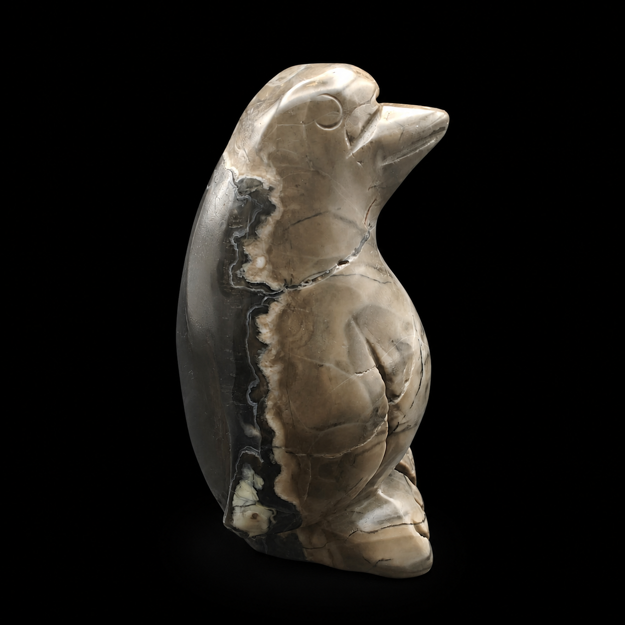 Opposite side view of a volcanic agate penguin carving with natural smoky beige patterns, dark agate banding and polished finish, 549g