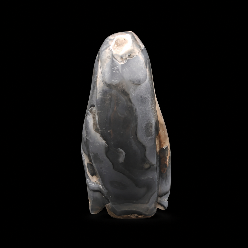 Back view of a UV reactive volcanic agate penguin carving 465g with smoky grey volcanic agate details