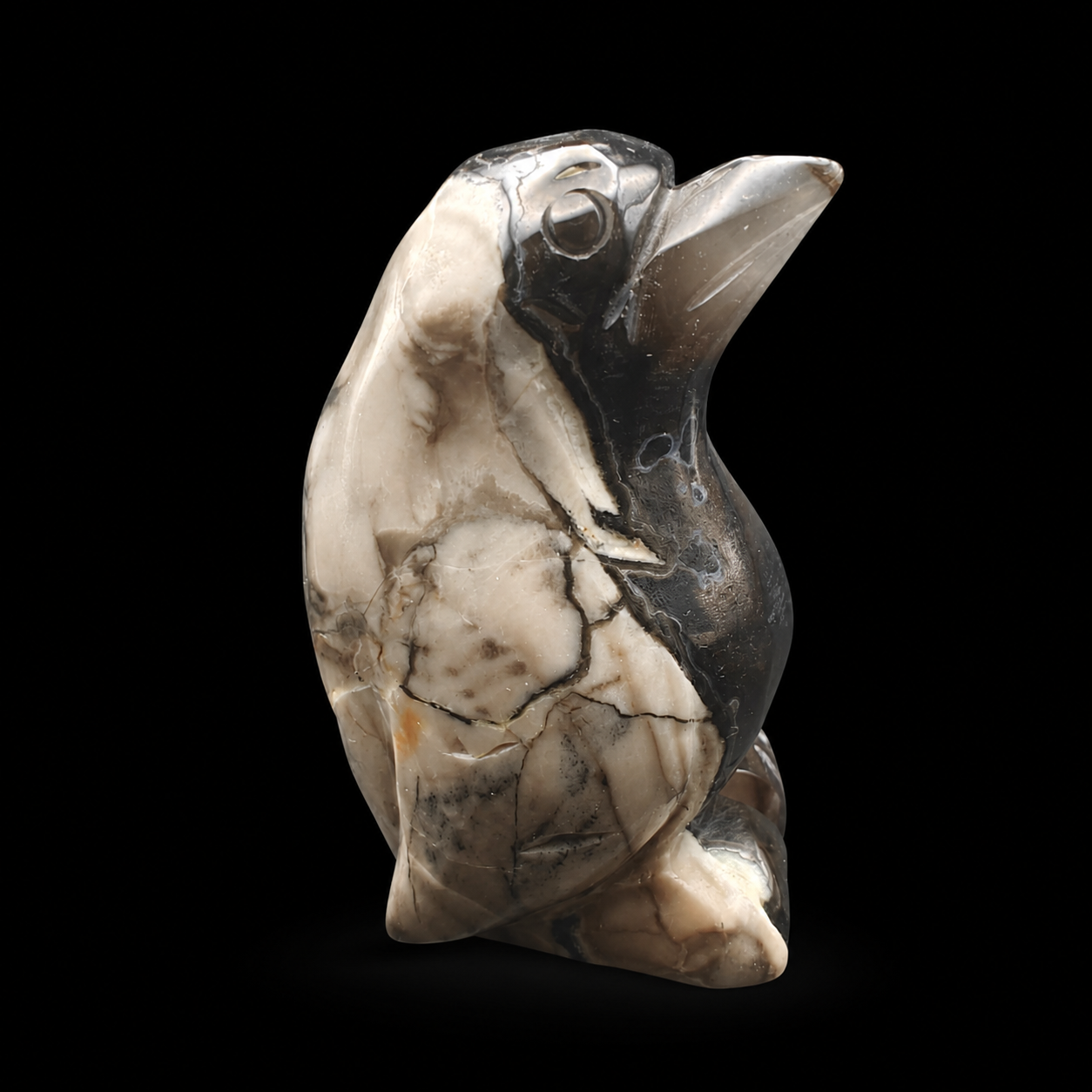 UV reactive volcanic agate penguin carving 533g opposite side view with black and cream contrast and polished finish
